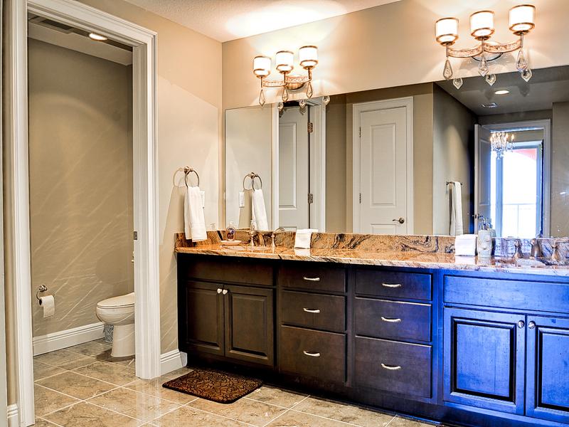 Spacious master bathroom has his and hers sinks and private lavatory.